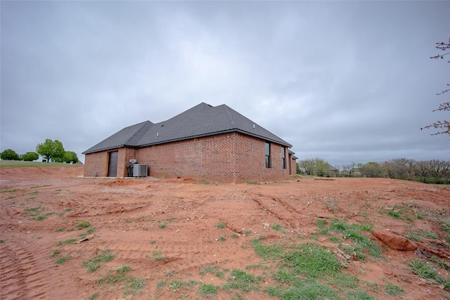 2040 County Road 1336, Blanchard, OK 73010 - view of property exterior featuring brick siding and central air condition unit