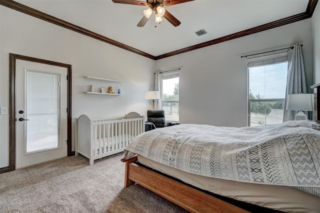bedroom featuring a ceiling fan, ornamental molding, visible vents, and carpet
