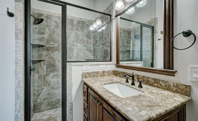 full bath featuring vanity and a stall shower