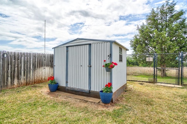 view of shed with a gate and a fenced backyard