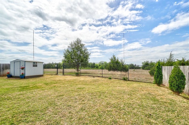 view of yard with an outdoor structure, a shed, and fence