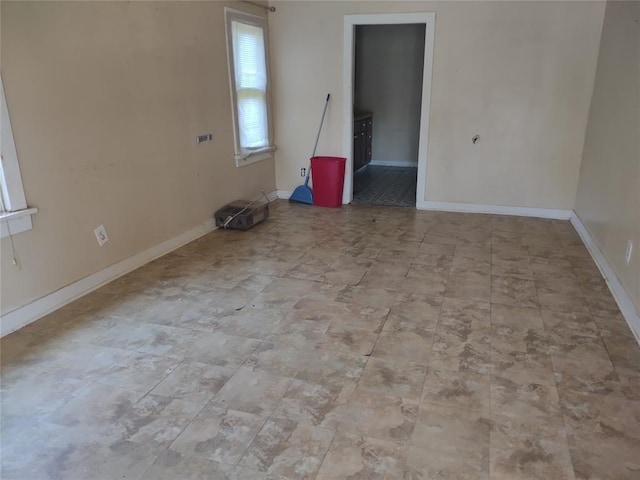 411 E 2nd St, Carnegie, OK 73015 - spare room featuring baseboards