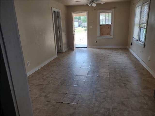 411 E 2nd St, Carnegie, OK 73015 - unfurnished room featuring ceiling fan and baseboards