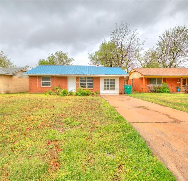416 NW 81st St, Oklahoma City, OK 73114 - ranch-style house featuring a front lawn, metal roof, and concrete driveway