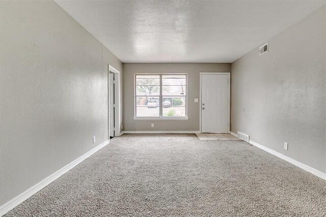 416 NW 81st St, Oklahoma City, OK 73114 - spare room with a textured ceiling, a textured wall, baseboards, and visible vents