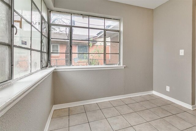 416 NW 81st St, Oklahoma City, OK 73114 - unfurnished room featuring baseboards, light tile patterned flooring, and a textured wall