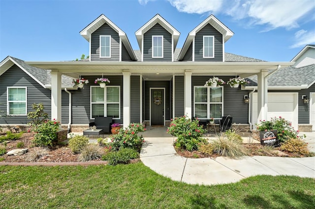 view of front of home with a porch and roof with shingles
