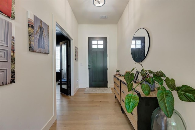 interior space with visible vents, light wood-type flooring, and baseboards