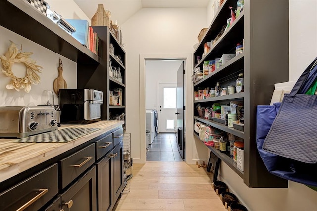 interior space featuring wood counters, a toaster, light wood-style floors, and open shelves