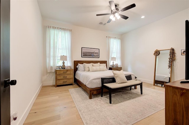 bedroom with visible vents, baseboards, ceiling fan, and light wood-type flooring