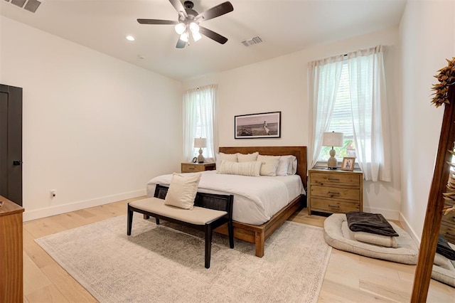 bedroom with visible vents, baseboards, and light wood-style floors