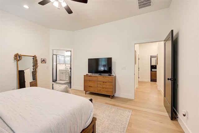 bedroom featuring connected bathroom, visible vents, baseboards, recessed lighting, and light wood finished floors