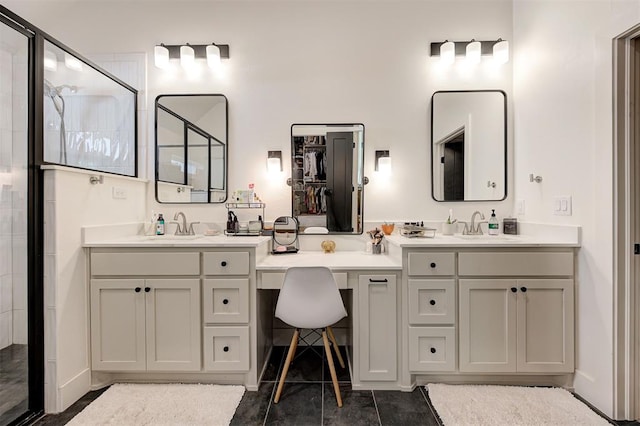 full bathroom featuring tile patterned floors, a stall shower, and vanity