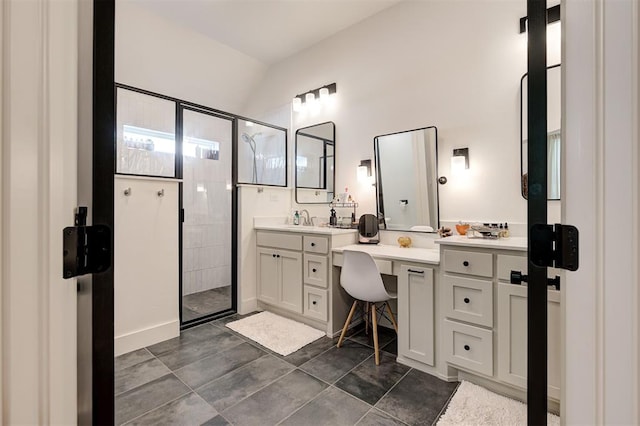bathroom with a shower stall, vaulted ceiling, and vanity