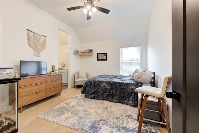 bedroom with lofted ceiling, light wood-style floors, and a ceiling fan