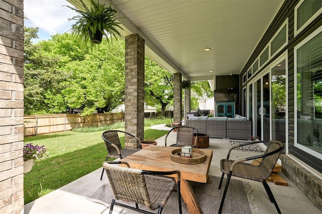 view of patio / terrace with outdoor dining space, an outdoor living space, and a fenced backyard
