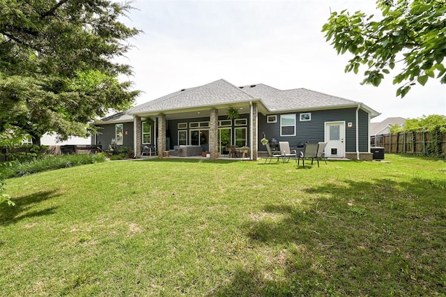 back of property featuring a patio, fence, and a lawn