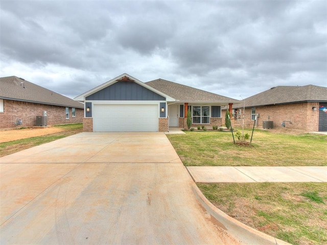 1680 Addington Rd, Newcastle, OK 73065 - view of front of property with a front yard, an attached garage, driveway, and central air condition unit