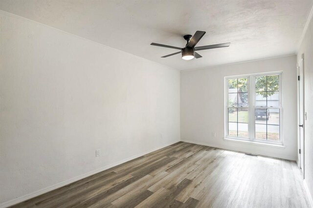 1021 NW 167th St, Edmond, OK 73012 - spare room with wood finished floors, baseboards, a ceiling fan, and visible vents