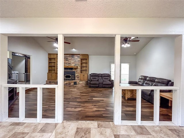 1016 Canyon Ridge Rd, Clinton, OK 73601 - living room with lofted ceiling, a fireplace, a ceiling fan, and built in shelves