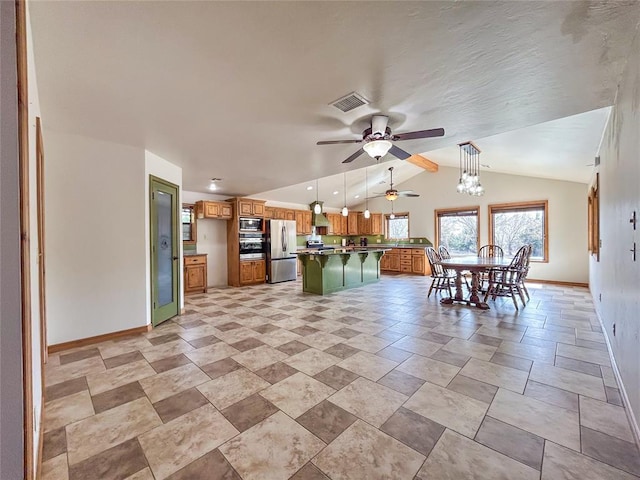 1016 Canyon Ridge Rd, Clinton, OK 73601 - kitchen with brown cabinets, ceiling fan, baseboards, freestanding refrigerator, and lofted ceiling