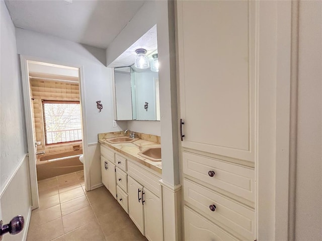 1016 Canyon Ridge Rd, Clinton, OK 73601 - bathroom with double vanity, toilet, tile patterned floors, and a sink