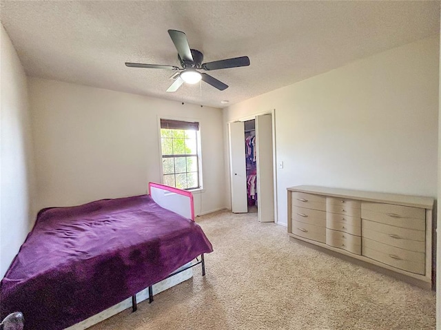 1016 Canyon Ridge Rd, Clinton, OK 73601 - bedroom with a textured ceiling, a closet, a ceiling fan, and light carpet