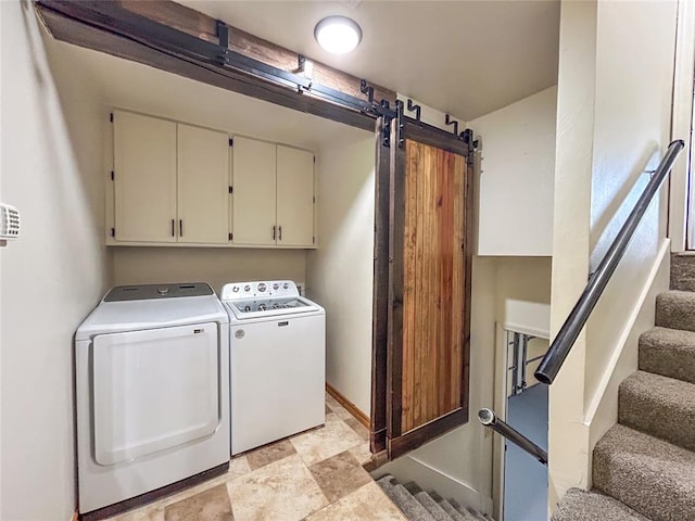 1016 Canyon Ridge Rd, Clinton, OK 73601 - laundry room featuring stone finish floor, independent washer and dryer, a barn door, baseboards, and cabinet space