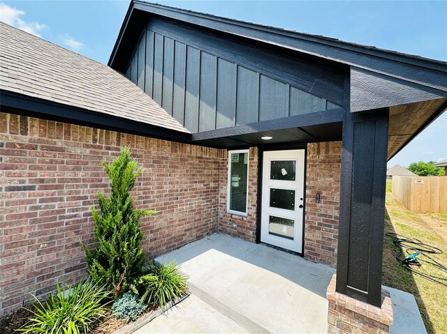1101 SW 139th St, Oklahoma City, OK 73170 - entrance to property with board and batten siding, brick siding, and a patio area