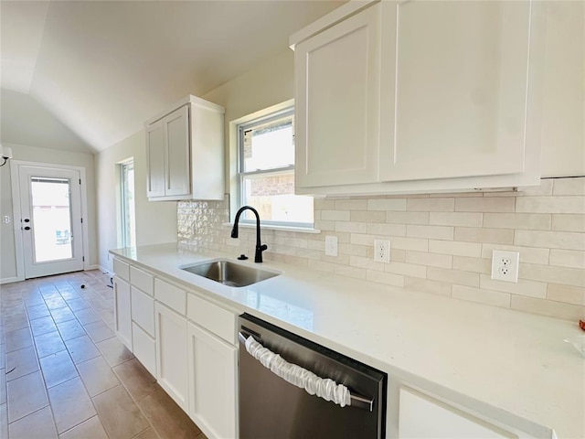 1101 SW 139th St, Oklahoma City, OK 73170 - kitchen featuring dishwasher, a sink, vaulted ceiling, backsplash, and light countertops
