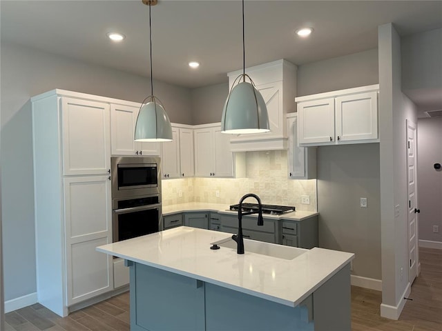 1220 SW 139th St, Oklahoma City, OK 73170 - kitchen with wood finished floors, appliances with stainless steel finishes, decorative backsplash, light countertops, and recessed lighting