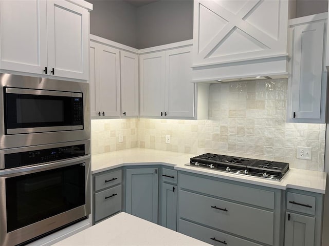 1220 SW 139th St, Oklahoma City, OK 73170 - kitchen featuring stainless steel appliances, gray cabinetry, light countertops, and tasteful backsplash