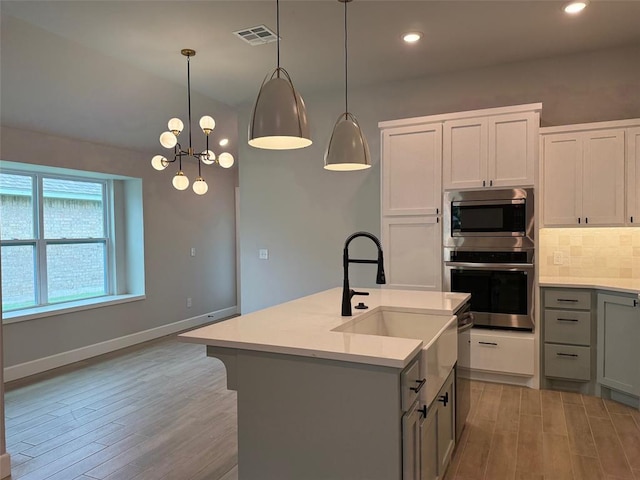 1220 SW 139th St, Oklahoma City, OK 73170 - kitchen featuring appliances with stainless steel finishes, light wood-style floors, light countertops, backsplash, and recessed lighting