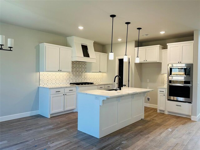 1221 SW 141st St, Oklahoma City, OK 73170 - kitchen featuring stainless steel appliances, a sink, premium range hood, white cabinetry, and recessed lighting