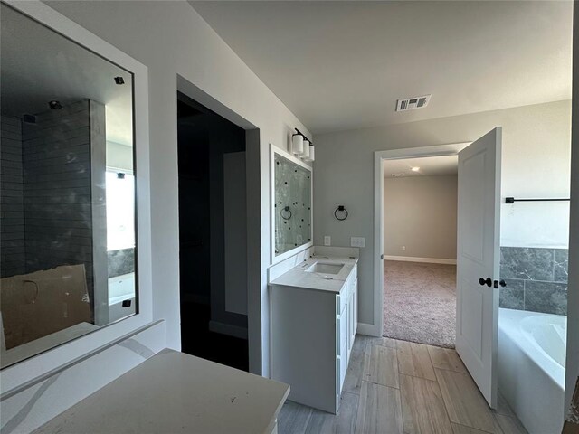 1221 SW 141st St, Oklahoma City, OK 73170 - full bathroom with a bath, vanity, baseboards, a shower, and wood finished floors