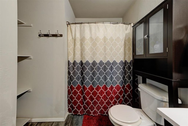1641 Tumbleweed Way, El Reno, OK 73036 - bathroom with curtained shower, toilet, and wood finished floors