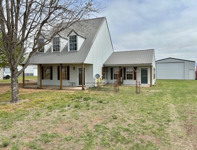713 Whispering Water Dr, Fort Cobb, OK 73038 - new england style home with a porch, a garage, and a front lawn