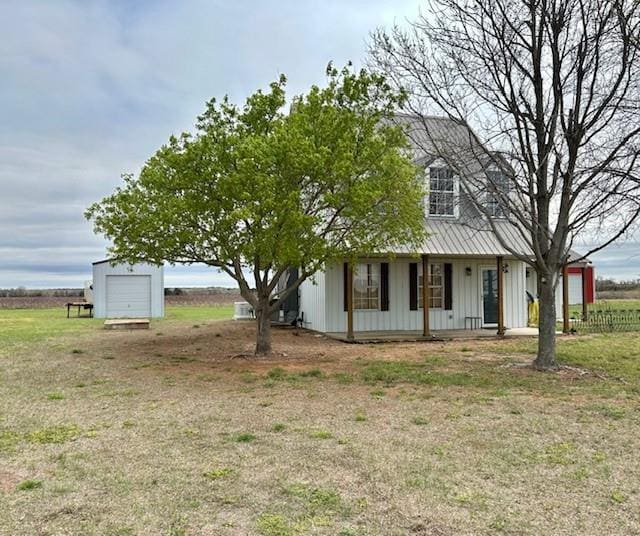 713 Whispering Water Dr, Fort Cobb, OK 73038 - view of front of home featuring an outbuilding, board and batten siding, and a detached garage