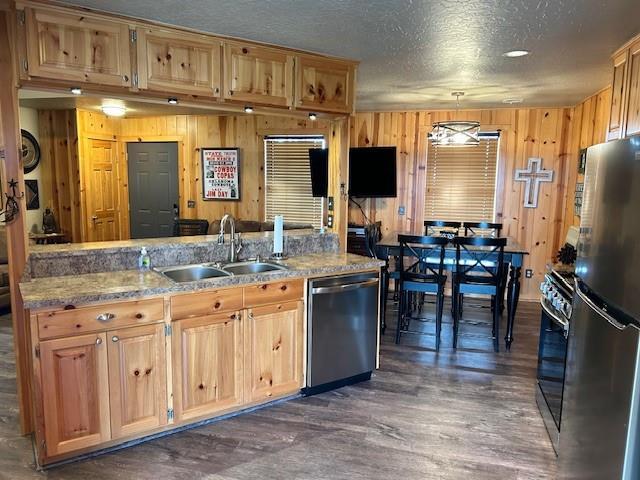 713 Whispering Water Dr, Fort Cobb, OK 73038 - kitchen with wooden walls, a sink, and appliances with stainless steel finishes