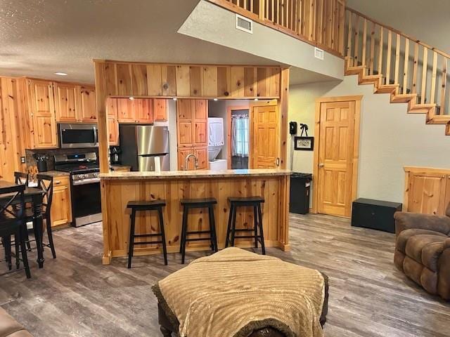 713 Whispering Water Dr, Fort Cobb, OK 73038 - kitchen with visible vents, light countertops, wood finished floors, and appliances with stainless steel finishes