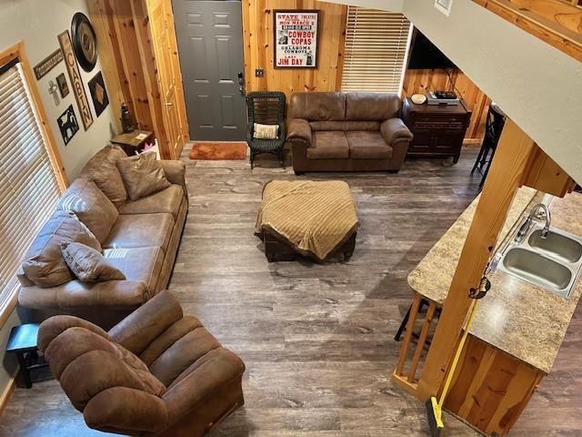 713 Whispering Water Dr, Fort Cobb, OK 73038 - living area with wood walls and dark wood finished floors