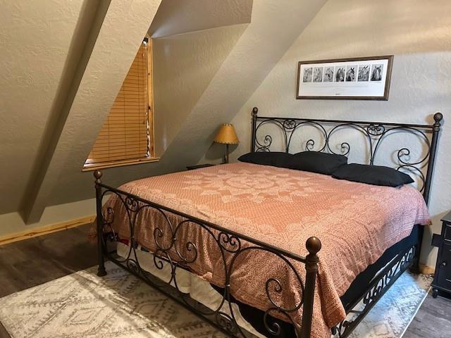 713 Whispering Water Dr, Fort Cobb, OK 73038 - bedroom with baseboards, wood finished floors, and lofted ceiling
