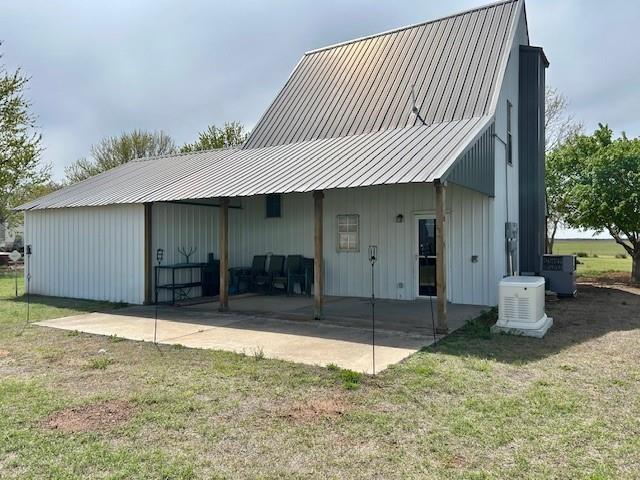 713 Whispering Water Dr, Fort Cobb, OK 73038 - back of house featuring a yard, a patio, cooling unit, and metal roof