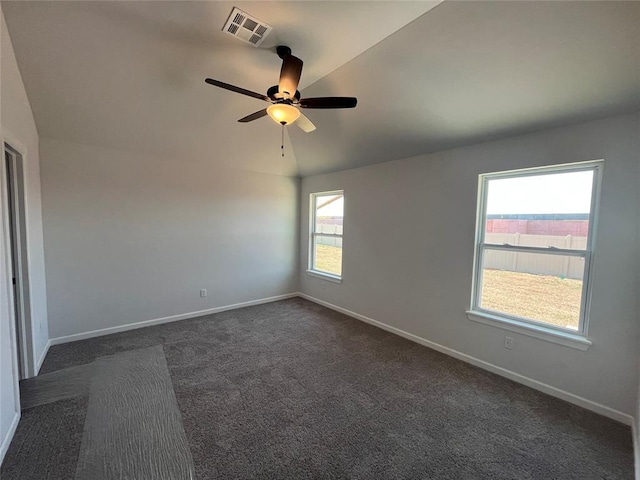 18117 Austin Ct, Edmond, OK 73012 - empty room featuring dark colored carpet, visible vents, ceiling fan, and baseboards