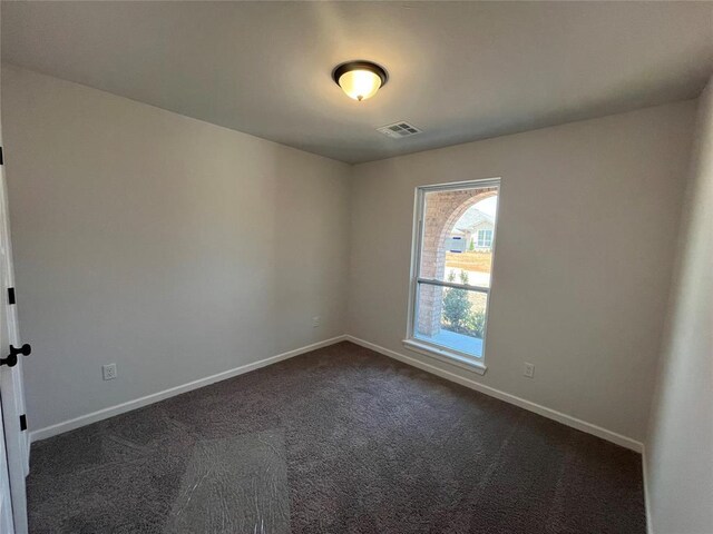 18117 Austin Ct, Edmond, OK 73012 - unfurnished room featuring dark carpet, visible vents, and baseboards
