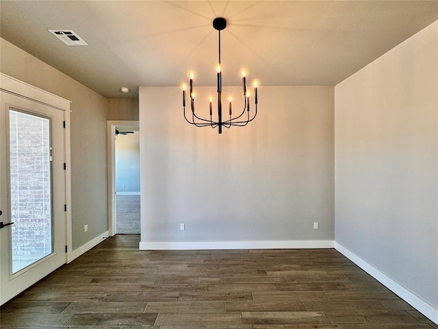 10116 NW 100th St, Yukon, OK 73099 - empty room with a chandelier and dark wood-style flooring