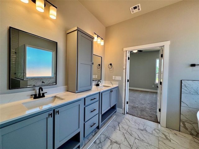 10116 NW 100th St, Yukon, OK 73099 - full bathroom with marble look tiles and double vanity