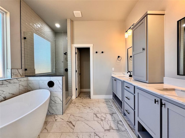 10116 NW 100th St, Yukon, OK 73099 - bathroom featuring marble finish floors, a freestanding bath, a stall shower, double vanity, and healthy amount of natural light
