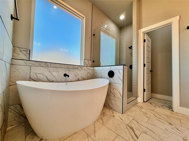 10116 NW 100th St, Yukon, OK 73099 - full bath with marble look tile flooring, a freestanding bath, tiled shower, recessed lighting, and tile walls