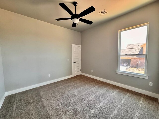 10116 NW 100th St, Yukon, OK 73099 - empty room with dark carpet and a ceiling fan